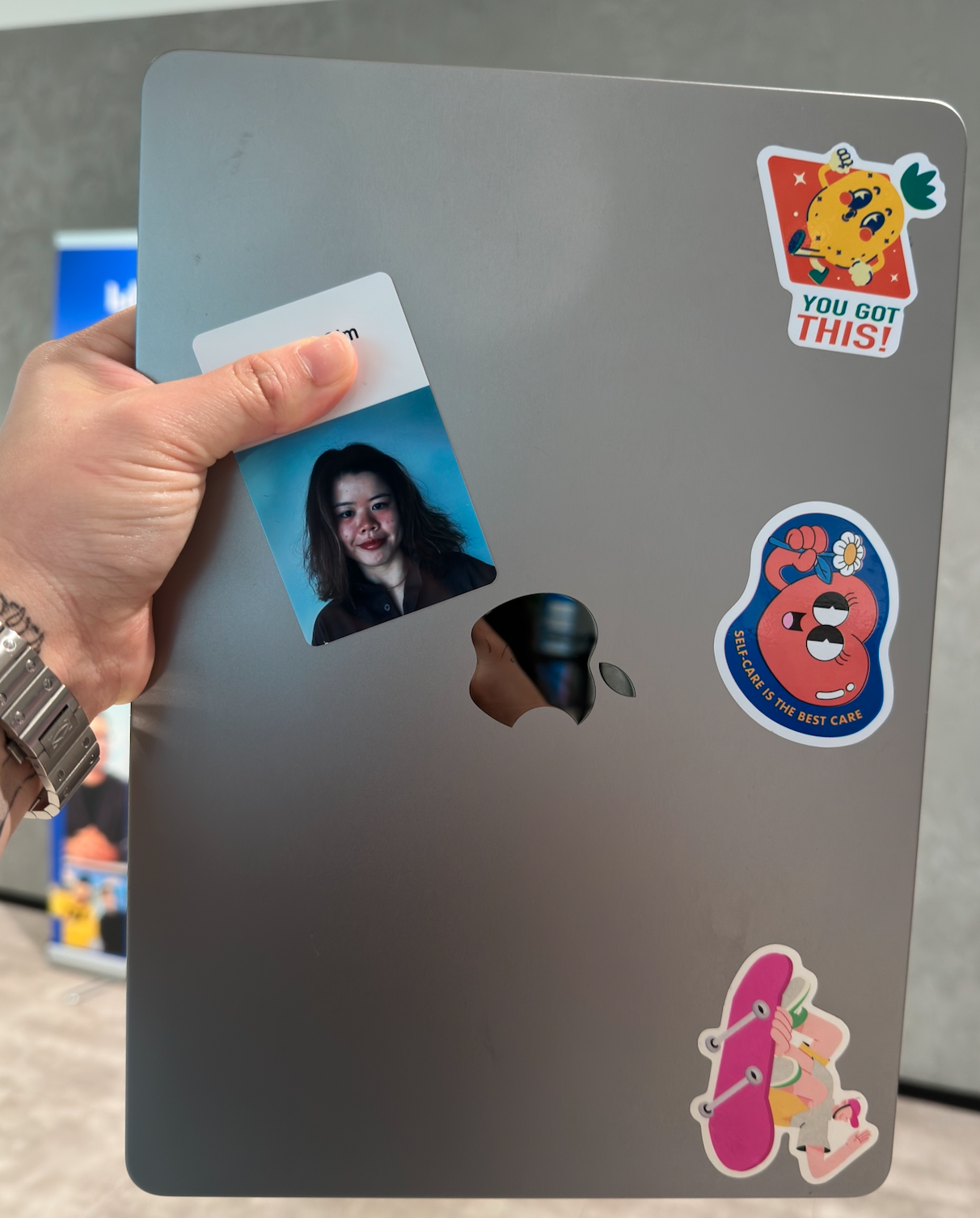 Mandy’s laptop with colourful stickers and her work badge